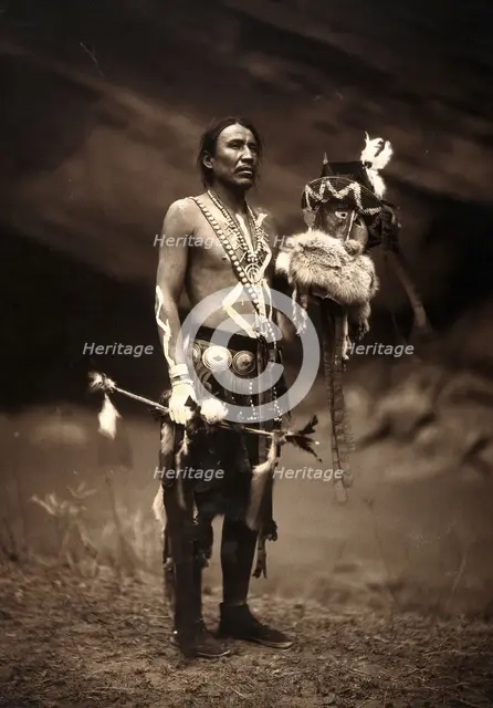 A Navajo man in ceremonial dress representing the Yebichai god Zahabolzi (Zahadolzha?), 1904. Creator: Edward Sheriff Curtis.