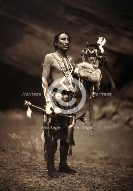 A Navajo man in ceremonial dress representing the Yebichai god Zahabolzi (Zahadolzha?), 1904. Creator: Edward Sheriff Curtis.