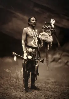 A Navajo man in ceremonial dress representing the Yebichai god Zahabolzi (Zahadolzha?), 1904. Creator: Edward Sheriff Curtis