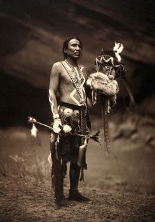 A Navajo man in ceremonial dress representing the Yebichai god Zahabolzi (Zahadolzha?), 1904. Creator: Edward Sheriff Curtis