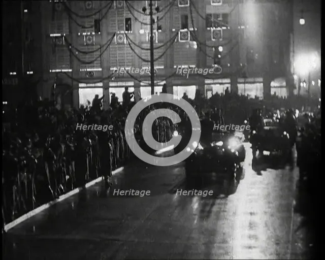 A Nazi Party Motorcade Driving Down a Berlin Street Lined With Crowds..., 1937. Creator: British Pathe Ltd.