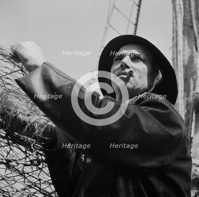 A New England fisherman preparing his boat to leave the New York docks, , New York, 1943. Creator: Gordon Parks.