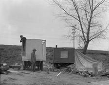 A new home on wheels (father and son), Yuba County, California, 1935. Creator: Dorothea Lange