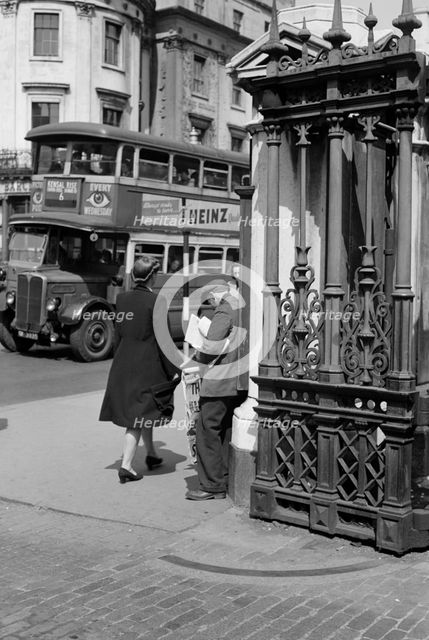 A newspaper seller at Charing Cross Station, London, c1945-c1955. Artist: SW Rawlings