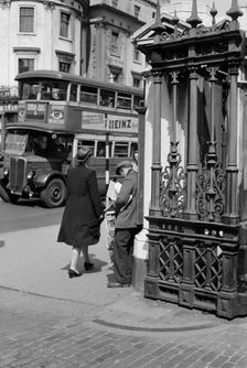 A newspaper seller at Charing Cross Station, London, c1945-c1955. Artist: SW Rawlings