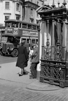 A newspaper seller at Charing Cross Station, London, c1945-c1955. Artist: SW Rawlings
