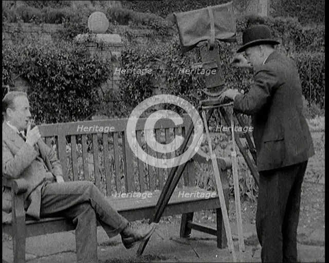 A Newsreel Camera Filming British Prime Minister Stanley Baldwin Sitting On a Bench in the..., 1924. Creator: British Pathe Ltd.