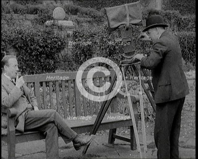 A Newsreel Camera Filming British Prime Minister Stanley Baldwin Sitting On a Bench in the..., 1924. Creator: British Pathe Ltd.
