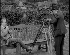 A Newsreel Camera Filming British Prime Minister Stanley Baldwin Sitting On a Bench in the..., 1924. Creator: British Pathe Ltd