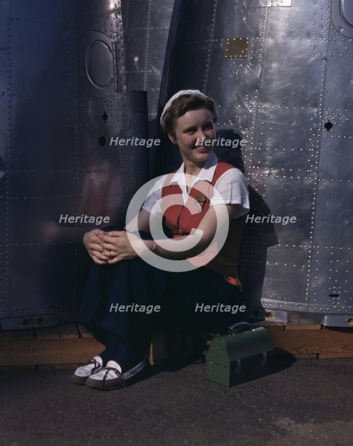 A noontime rest for a full-fledged...Long Beach, Calif., plant of Douglas Aircraft Company, 1942. Creator: Alfred T Palmer.