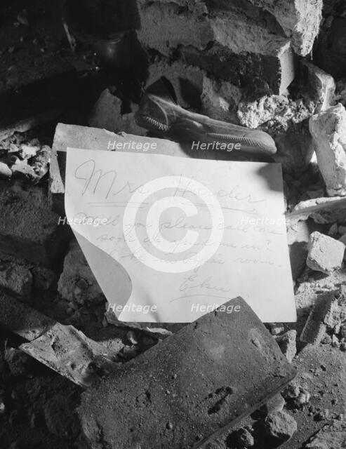 A note left in a wrecked house on Independence Avenue, Washington, D.C, 1942. Creator: Gordon Parks.