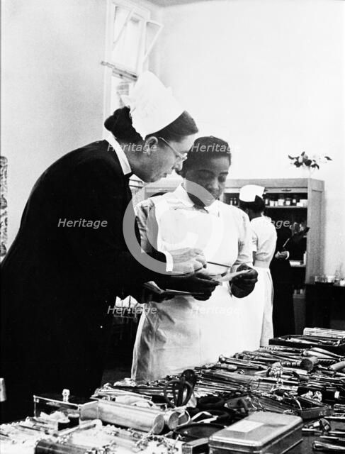 A nurse being trained, 1960. Creator: Henry Grant.