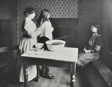 A nurse examines girls hair, Central Street Cleansing Station, London, 1914