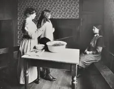 A nurse examines girls hair, Central Street Cleansing Station, London, 1914