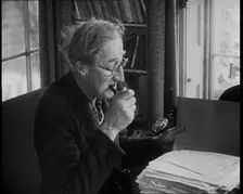 A.P. Herbert Inspecting Some Papers, 1930s. Creator: British Pathe Ltd