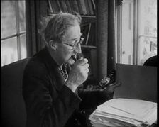 A.P. Herbert Inspecting Some Papers, 1930s. Creator: British Pathe Ltd