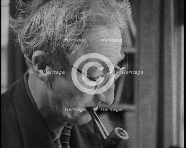 A.P. Herbert Smoking a Pipe, 1930s. Creator: British Pathe Ltd.