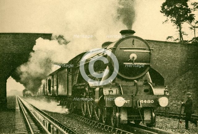 'A "Pacific" Engine Picking Up Water at the Rate of 2,500 Gallons in Ten Seconds - London and North  Creator: Unknown.