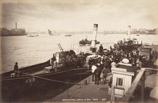 A paddle steamer disembarking passengers at Greenwich Pier, London, c1890