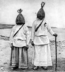 A pair of straw boys Ireland, 1922.Artist: AW Cutler
