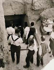 A party going down the steps to the tomb of Tutankhamun, Valley of the Kings, Egypt, 1923. Creator: Harry Burton