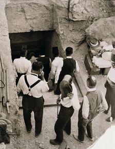 A party going down the steps to the tomb of Tutankhamun, Valley of the Kings, Egypt, 1923. Creator: Harry Burton