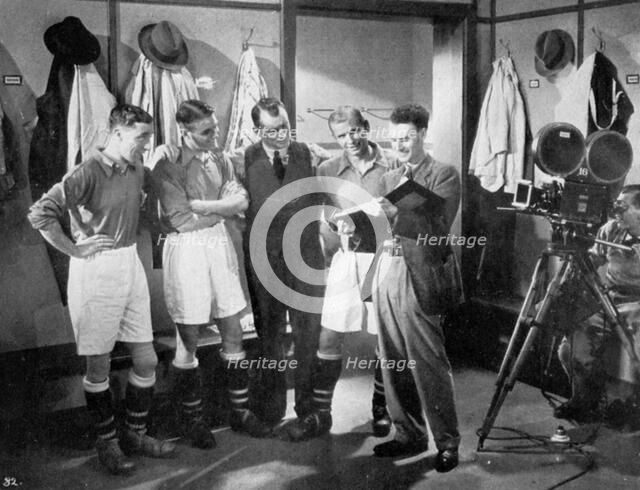 A pause for instruction from film producer Anthony Asquith, Twickenham, London, c1932. Artist: Unknown