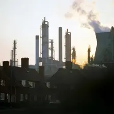 A petrochemical plant towering over residential housing, Baglan Bay, Wales, 1975. Creator: Michael Walters