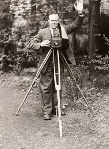 A photographer stands with his camera, County Industries, York, Yorkshire, 1943