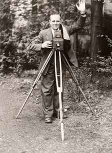 A photographer stands with his camera, County Industries, York, Yorkshire, 1943