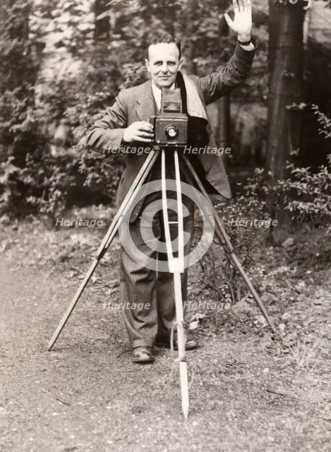 A photographer stands with his camera, County Industries, York, Yorkshire, 1943. Artist: Unknown