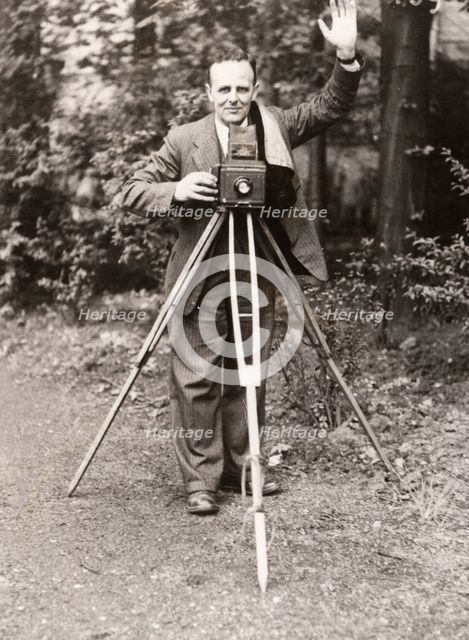 A photographer stands with his camera, County Industries, York, Yorkshire, 1943. Artist: Unknown