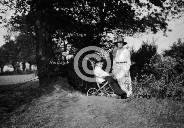 A physically disabled boy sitting in a wheelchair,  c1910/1925. Creator: Unknown.