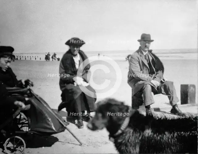 A physically disabled boy sitting in a wheelchair on a beach,  c1910/1925. Creator: Unknown.