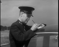 A Police Officer Writing a Ticket for a Car, 1940. Creator: British Pathe Ltd