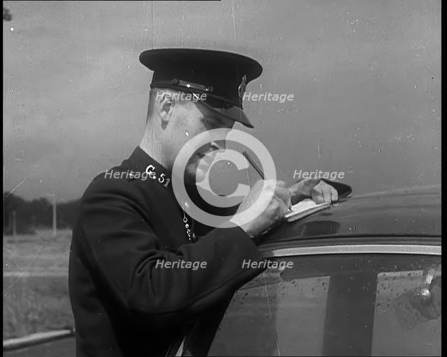 A Police Officer Writing a Ticket for a Car, 1940. Creator: British Pathe Ltd.