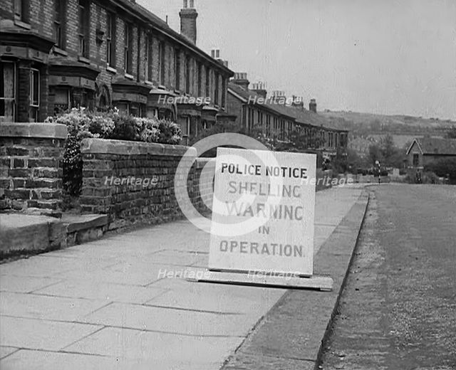 A Police Warning Notice of German Shelling, 1940. Creator: British Pathe Ltd.