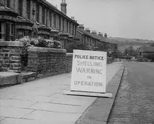 A Police Warning Notice of German Shelling, 1940. Creator: British Pathe Ltd