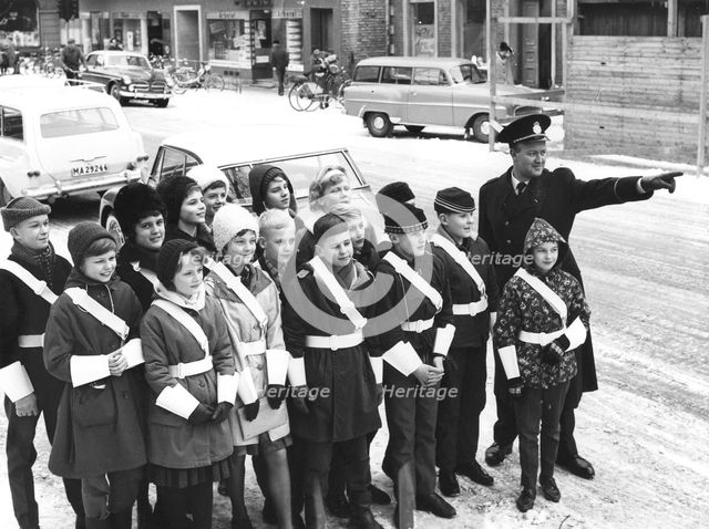 A policeman teaches a group of schoolchildren how to be traffic officers, Sweden, c1956-1969(?). Artist: Unknown