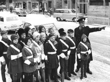 A policeman teaches a group of schoolchildren how to be traffic officers, Sweden, c1956-1969(?)