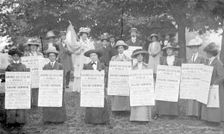A poster parade of suffragettes advertising a meeting to be held on Ealing Common, June 1912. Creator: Unknown