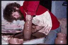 A potter working at a wheel in the Gladstone Pottery Museum, Longton, Stoke-on-Trent, 1975. Creator: Dorothy Chapman