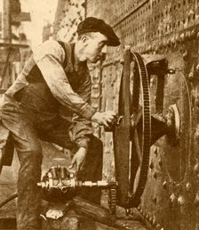 A Pneumatic Riveter Cutting Portholes in the Side of a Liner c1930. Creator: John Brown & Company