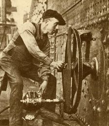 A Pneumatic Riveter Cutting Portholes in the Side of a Liner c1930. Creator: John Brown & Company