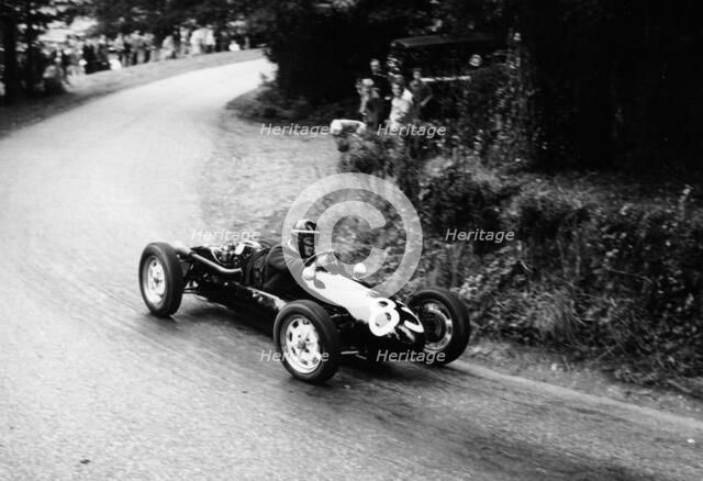 A racing driver speeding round a bend, Harleyford Hill Climb, Buckinghamshire, (c1950-c1960?). Artist: Unknown