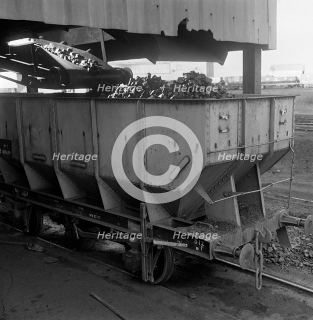 A rail truck being loaded with coal, Lynemouth Colliery, Northumberland, 1963. Creator: Michael Walters.