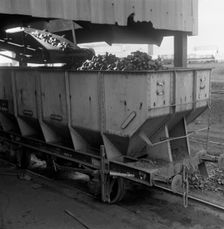A rail truck being loaded with coal, Lynemouth Colliery, Northumberland, 1963. Creator: Michael Walters