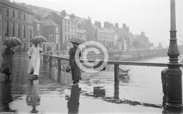 A rainy day on Pier Road, Whitby, North Yorkshire, 1896-1920. Artist: Alfred Newton & Sons.