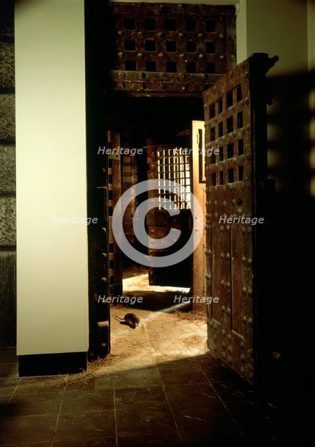 A reconstruction of a corridor in Newgate Gaol, with original doors. Creator: Unknown.