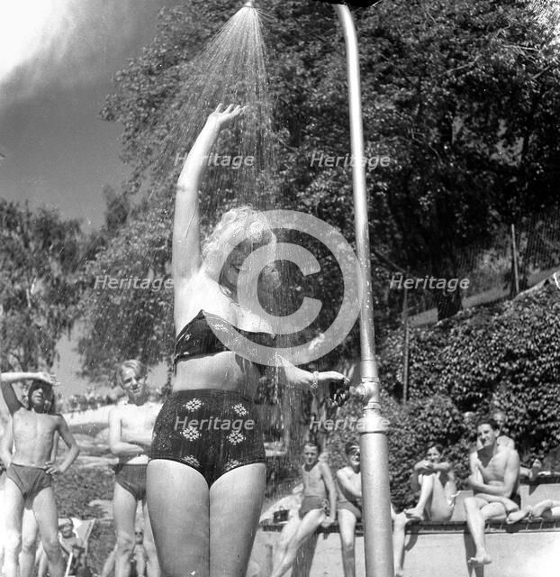 A refreshing shower during the heatwave in Stockholm, Sweden, 24th July 1943. Artist: Karl Sandels